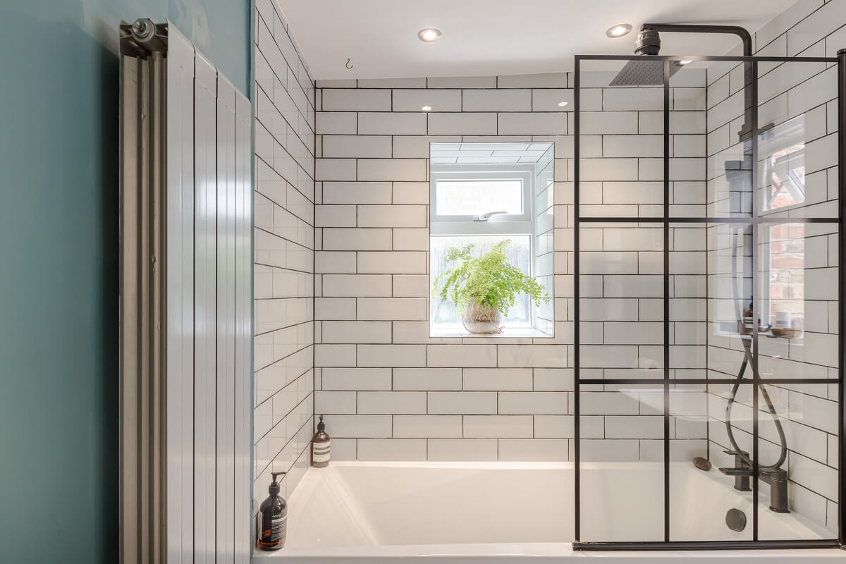 bathroom with shower and bath combination and white subway tiles nordroom