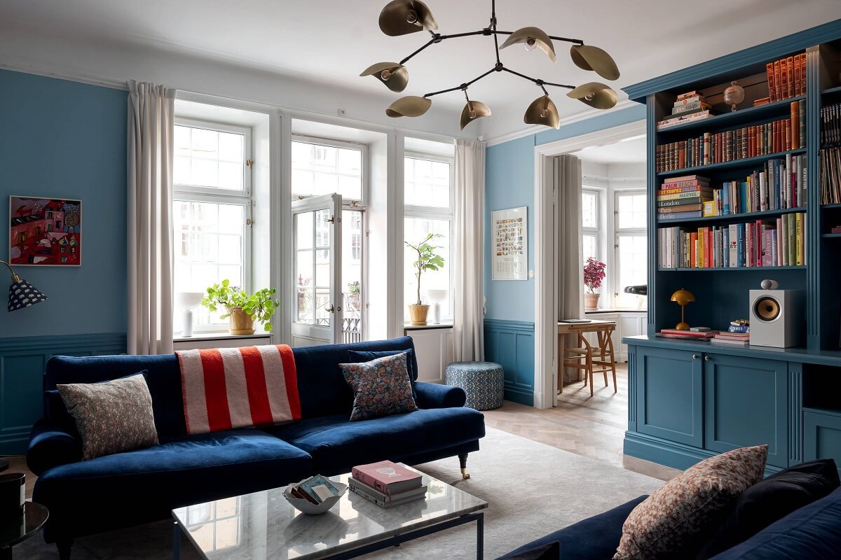 blue sofa in living room with built in bookcases
