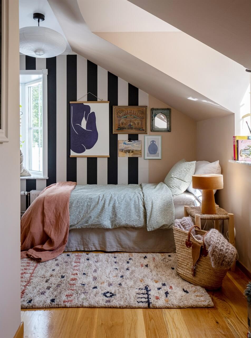 childrens bedroom with slanted ceiling and striped wallpaper nordroom