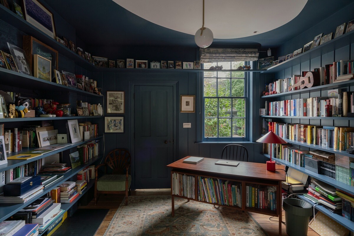 dark blue home office with bookshelves and midcentury desk nordroom
