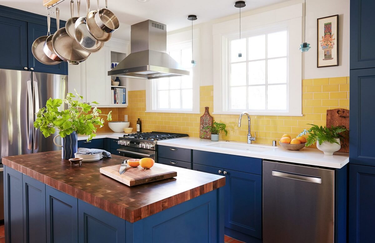 kitchen with blue cabinets and yellow tiles