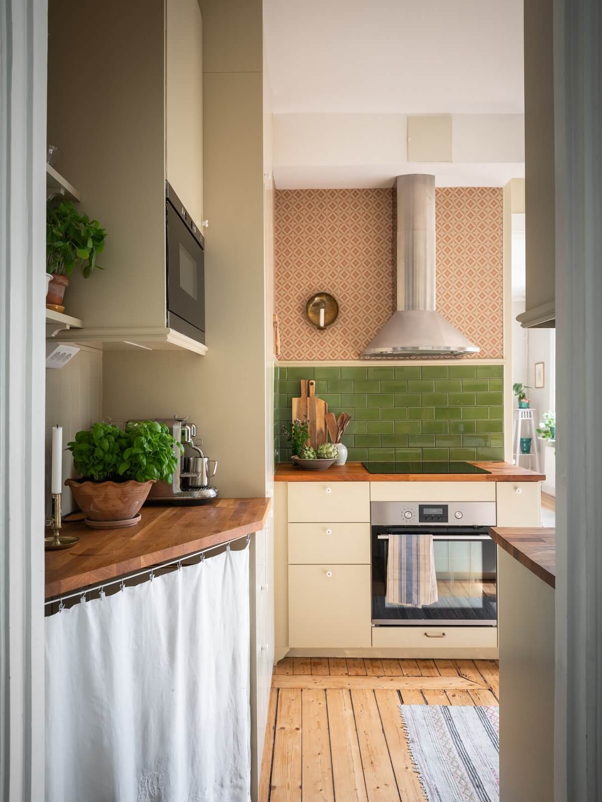 kitchen with green tiles and wooden floor