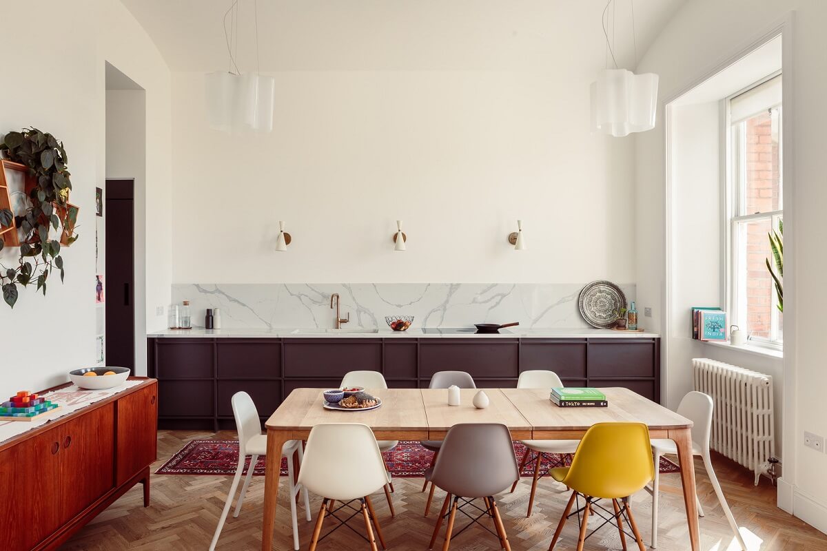 purple kitchen and large dining table with colorful eames chairs nordroom