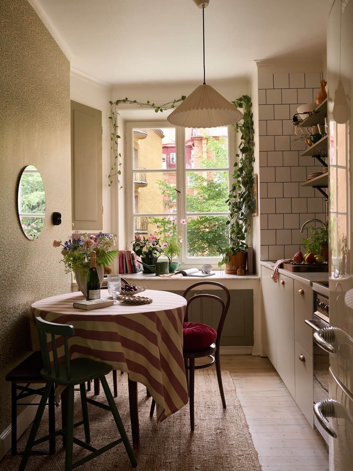 vintage kitchen with green cabinets round table and william morris wallpaper nordroom