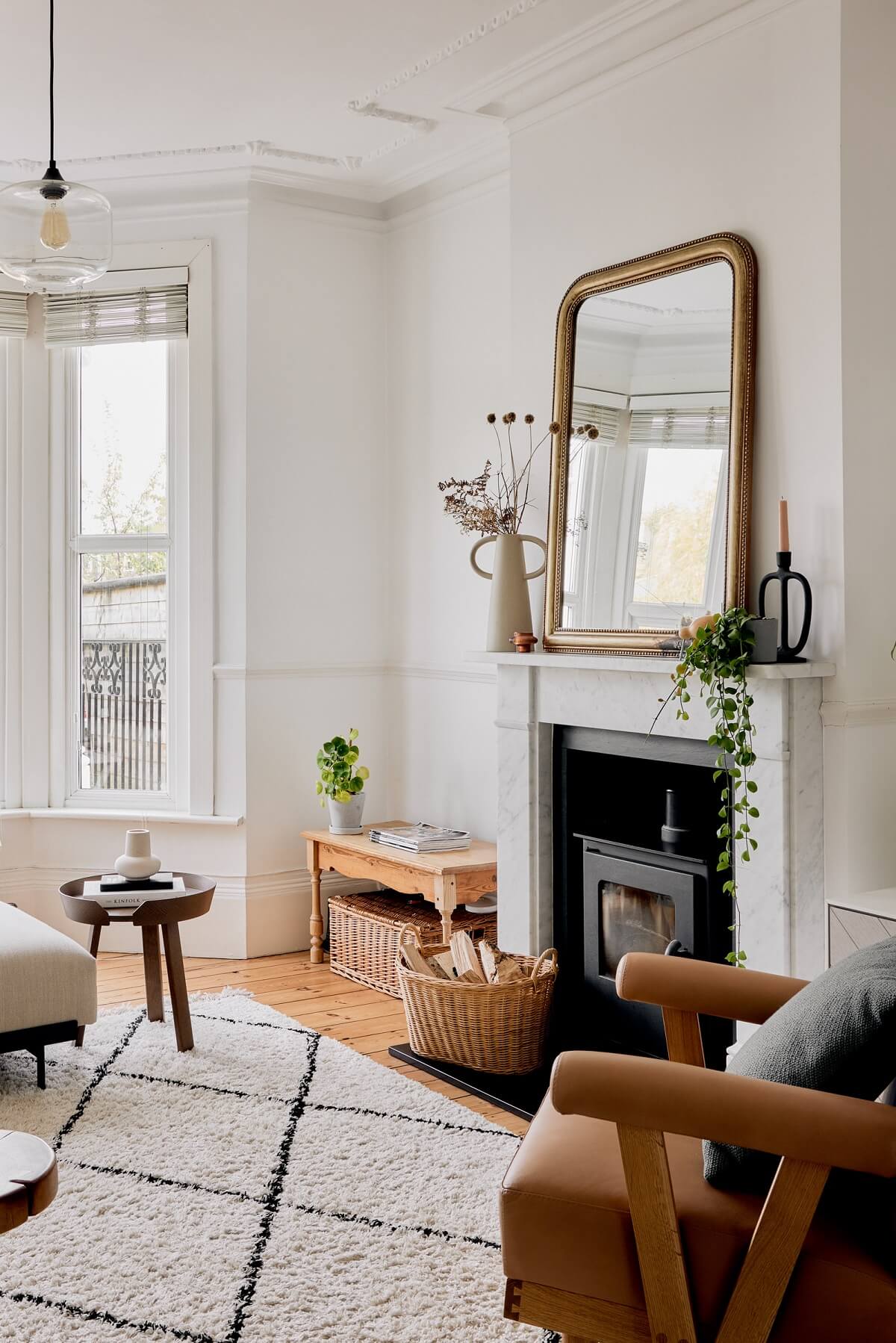 white living room with fireplace and rusty red armchair nordroom