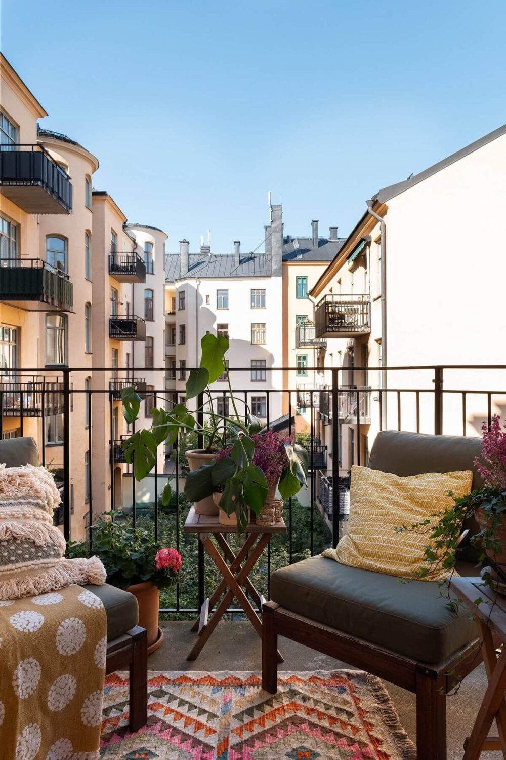 A Beautiful Turn-of-the-Century Apartment with Bold Color Accents 17 balcony with colorful rug