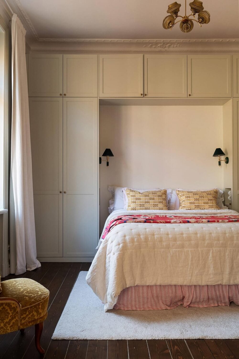 A Beautiful Turn-of-the-Century Apartment with Bold Color Accents 24 bedroom dark wooden floor wardrobes around the bed