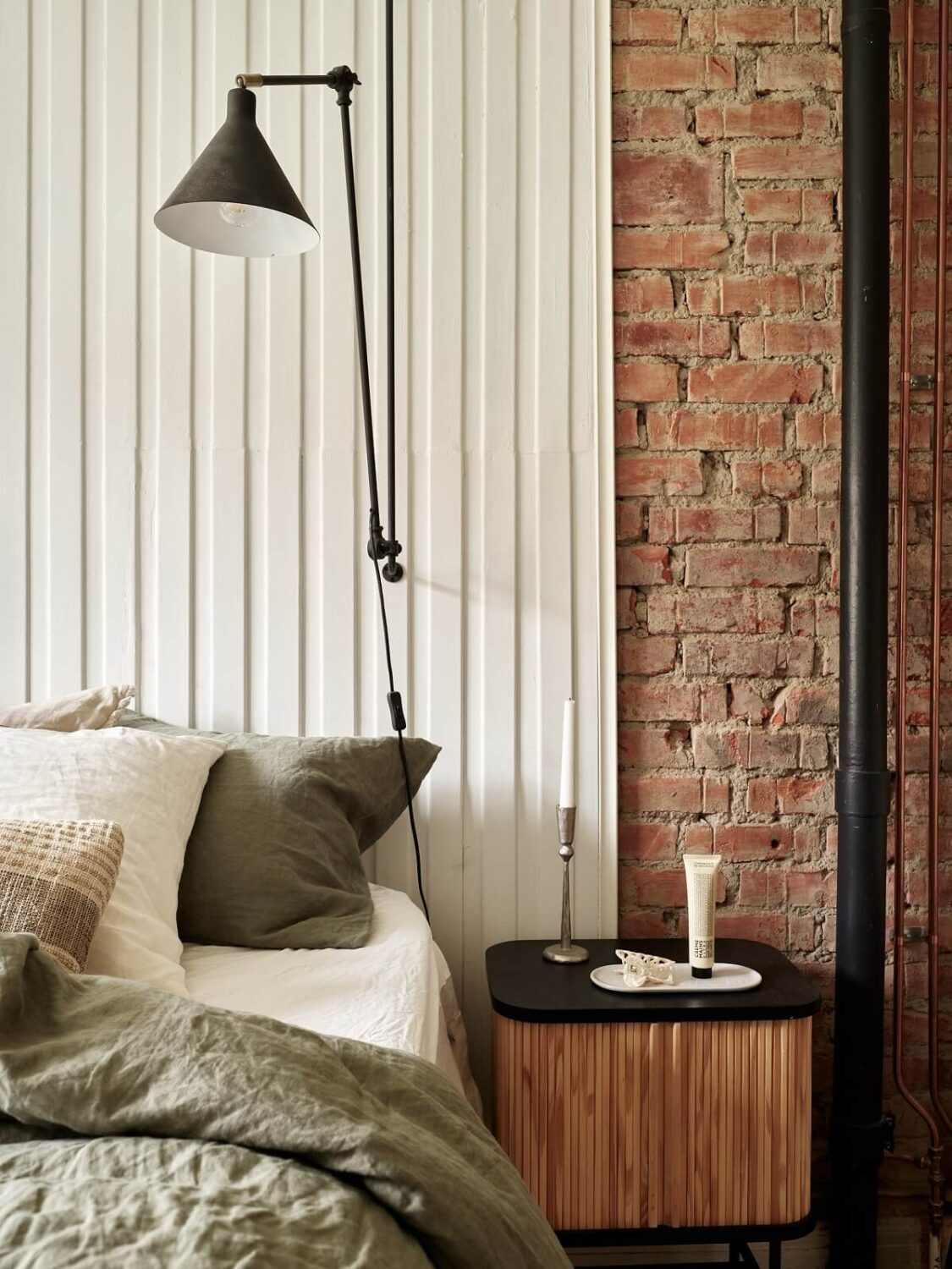 bedroom detail with wood and brick wall