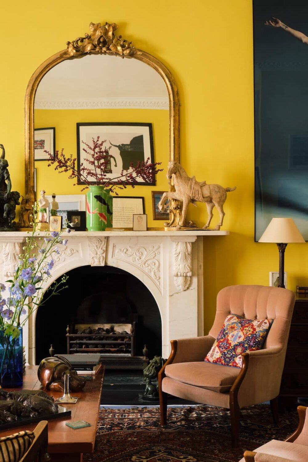bright yellow living room in period home with fireplace and gilded mirror nordroom
