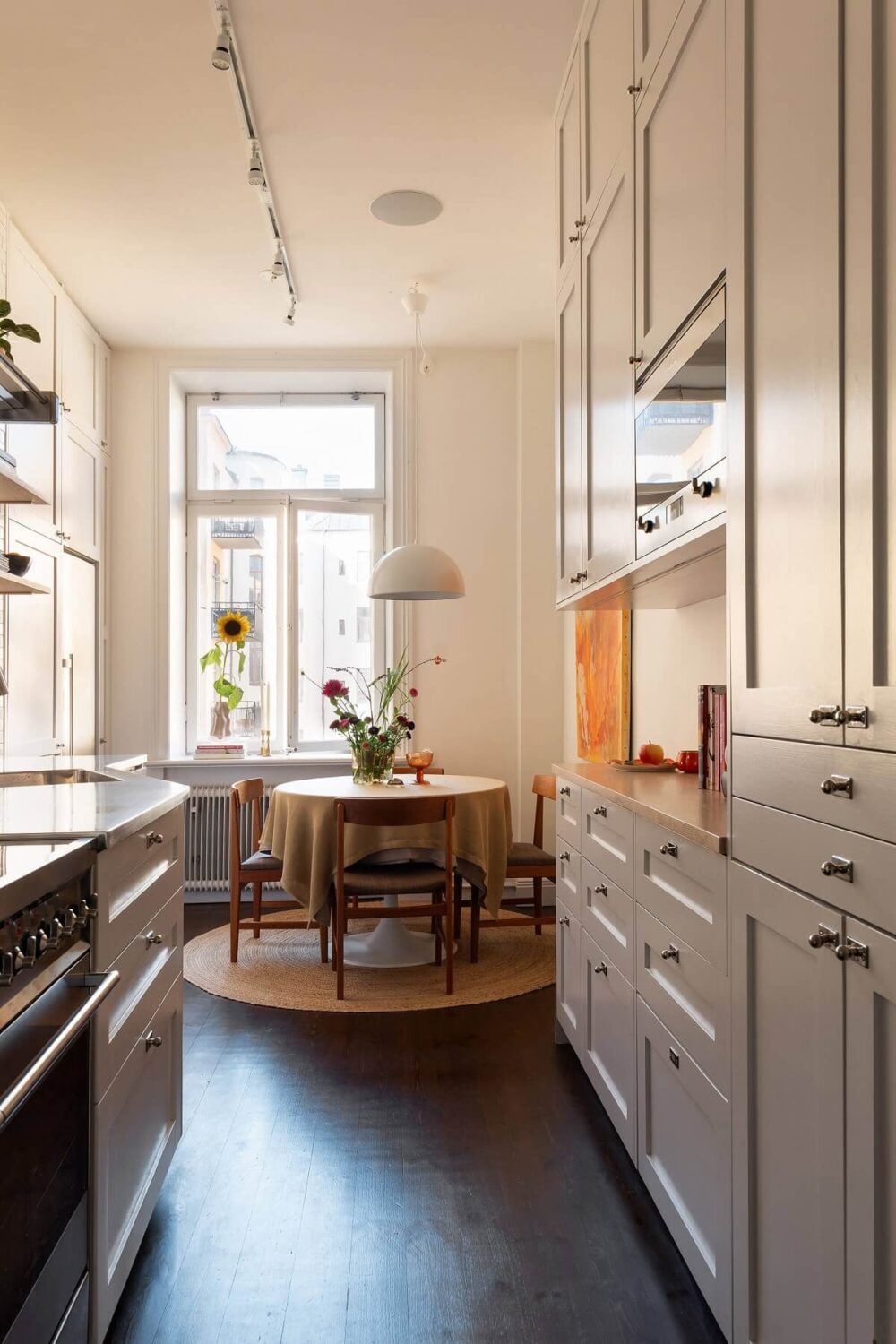 A Beautiful Turn-of-the-Century Apartment with Bold Color Accents 11 gray kitchen with round table