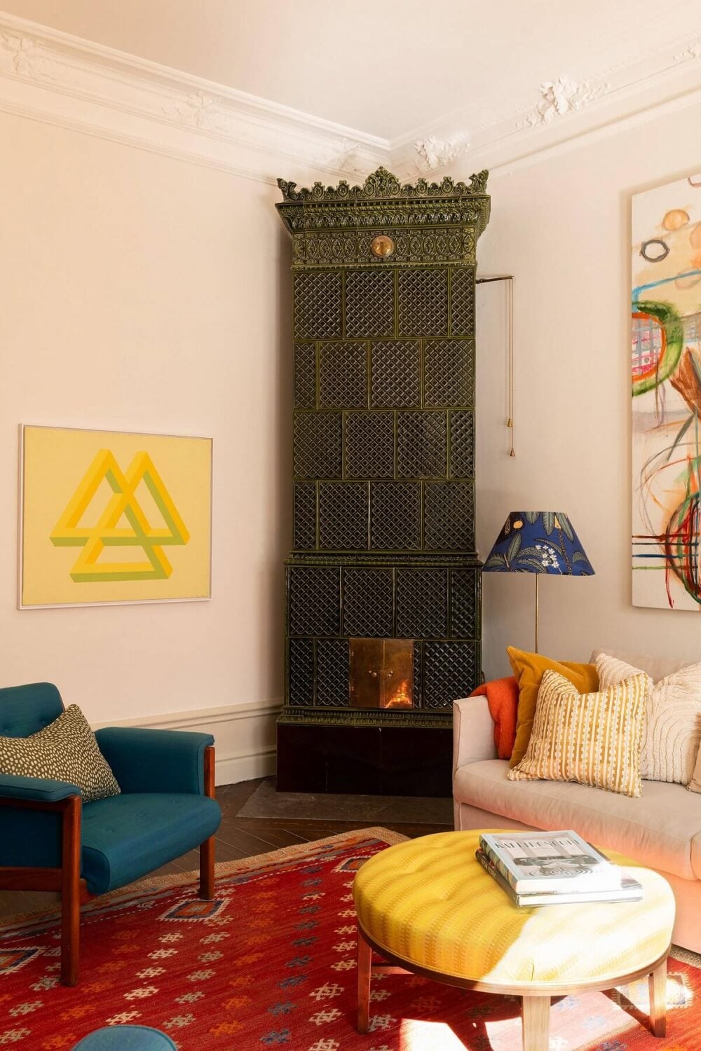 A Beautiful Turn-of-the-Century Apartment with Bold Color Accents 4 green fireplace blue chair red rug