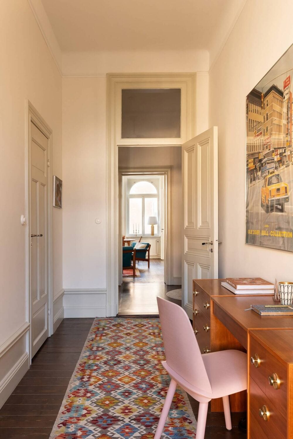 A Beautiful Turn-of-the-Century Apartment with Bold Color Accents 18 home office with colorful rug and pink chair