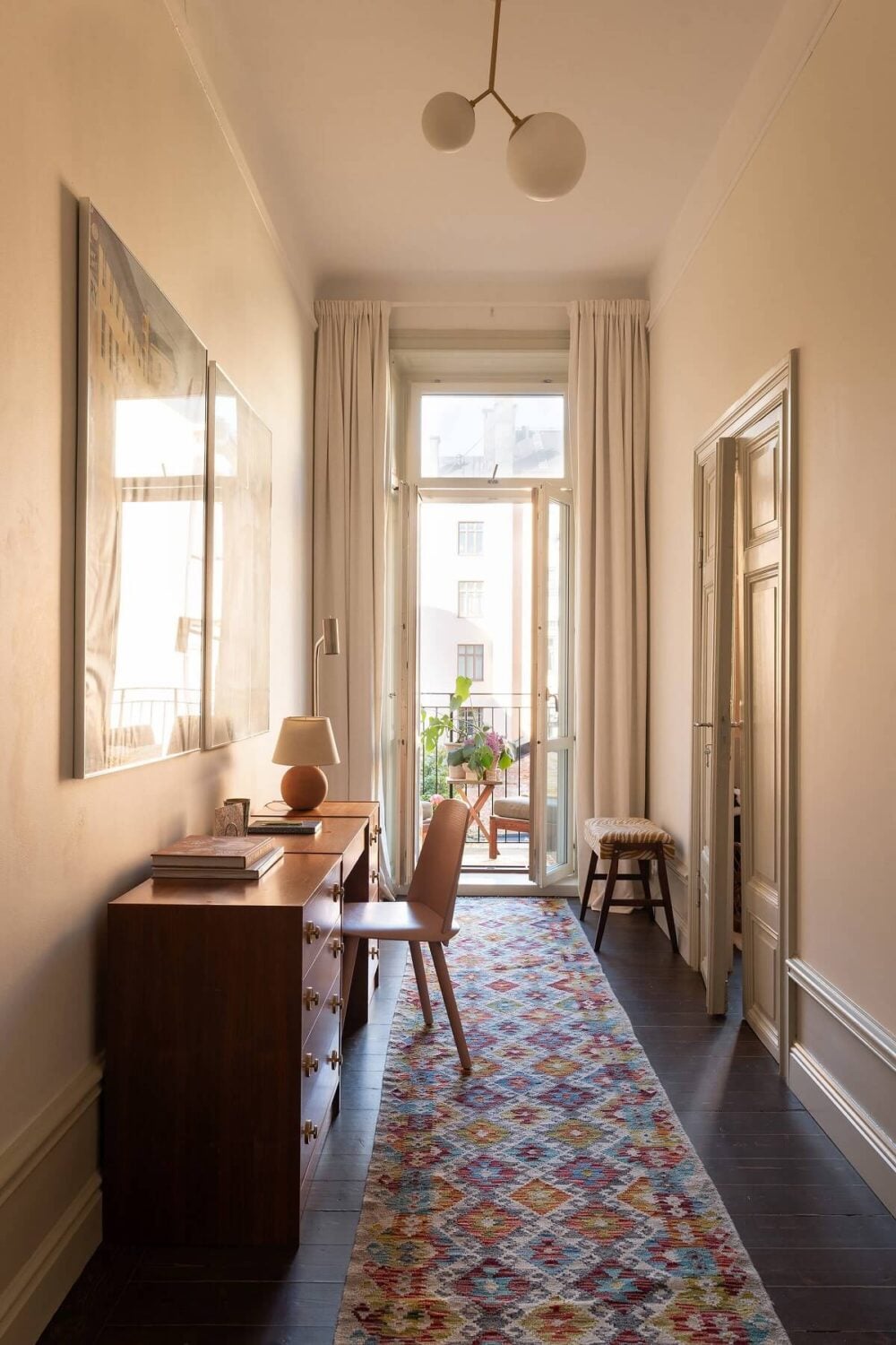 A Beautiful Turn-of-the-Century Apartment with Bold Color Accents 15 home office with colorful rug and wooden desk