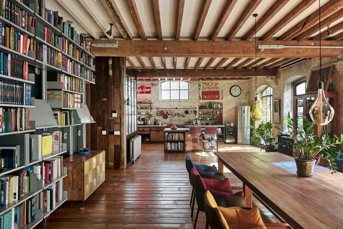 industrial open plan living space exposed beams bookcases