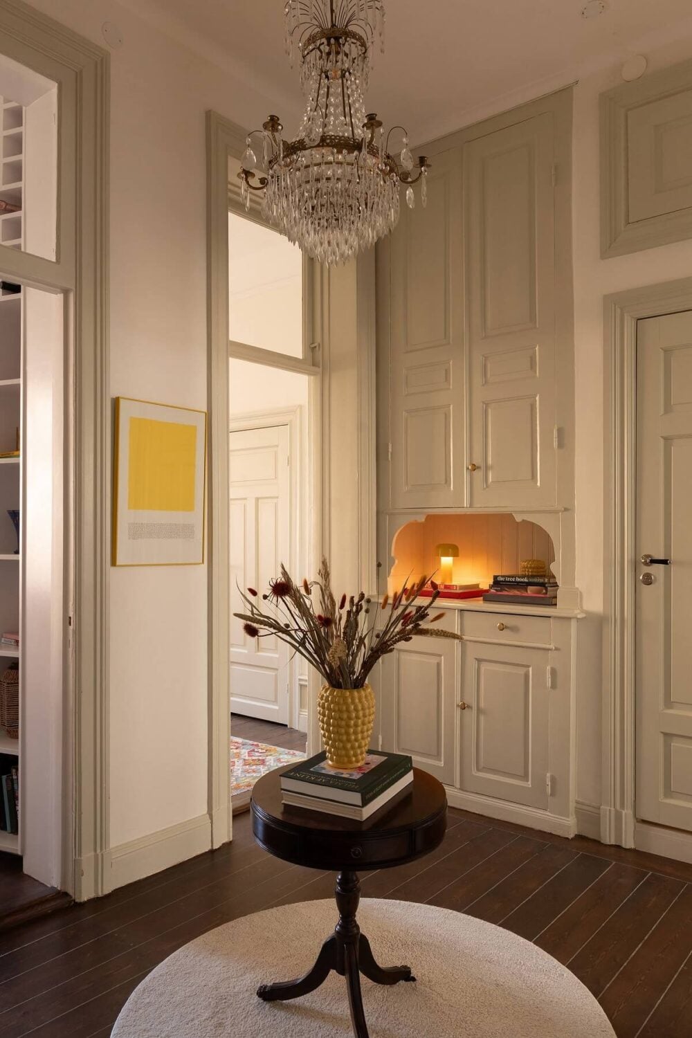 A Beautiful Turn-of-the-Century Apartment with Bold Color Accents 28 inner hall with small round table and original built in cabinets