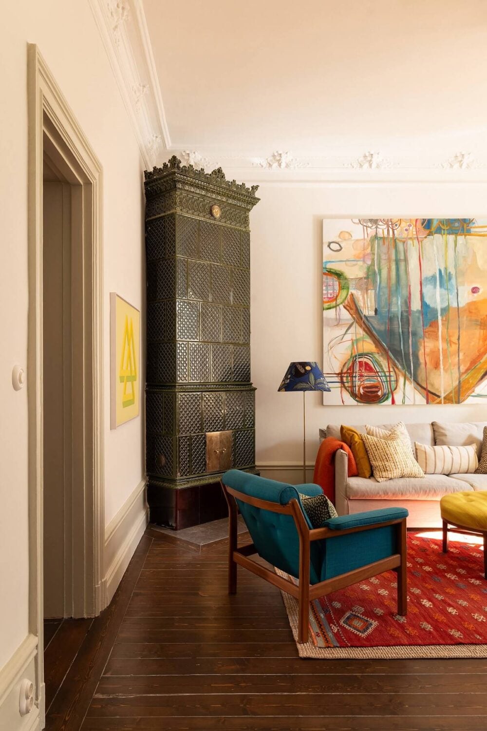 A Beautiful Turn-of-the-Century Apartment with Bold Color Accents 5 living room dark wooden floor green fireplace