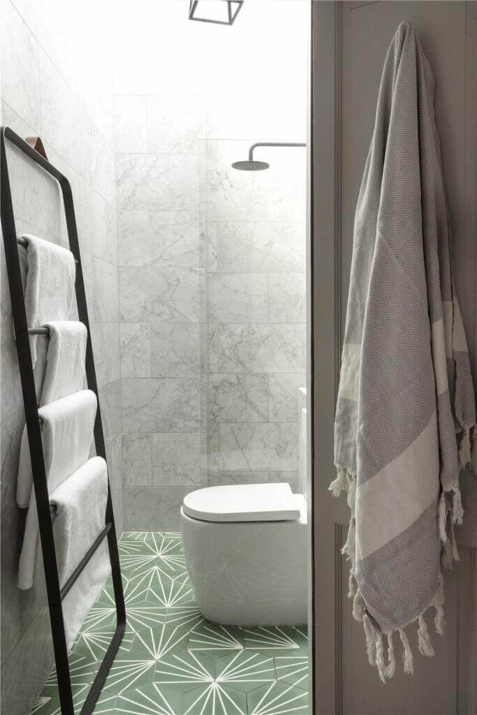 small bathroom with green patterned floor tiles