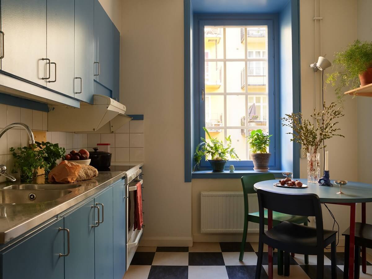 blue kitchen with small round table checkerboard floor nordroom