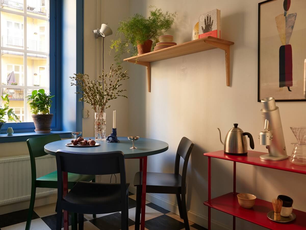 colorful kitchen with round table and checkerboard floor