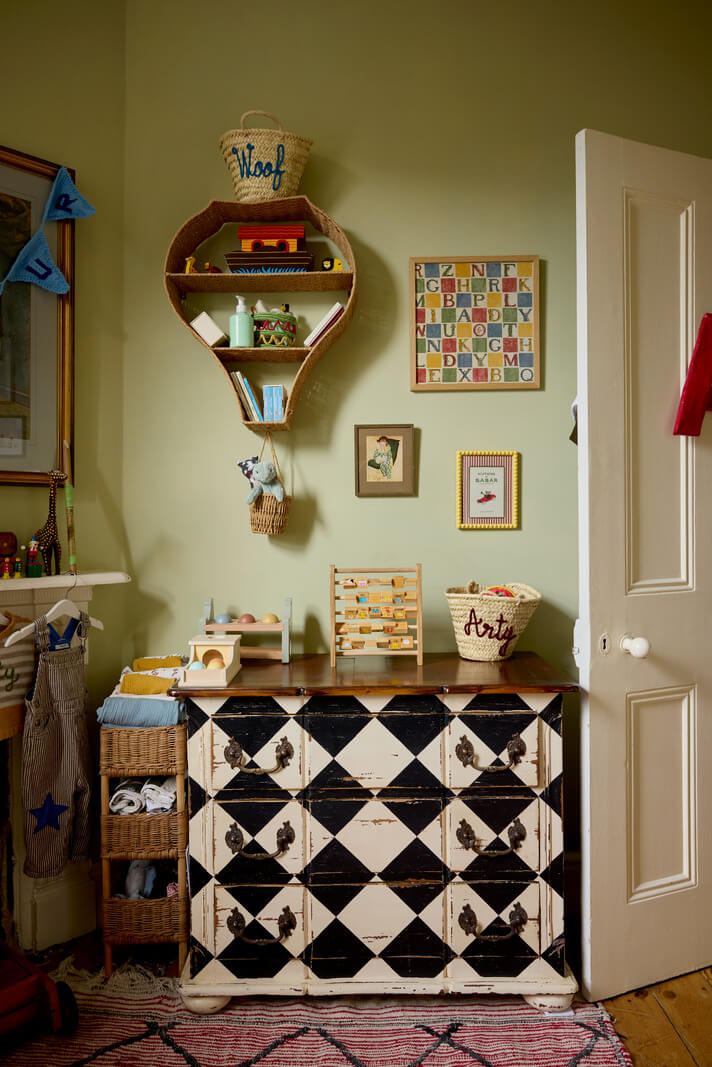 green nursery with checkerboard cabinet nordroom