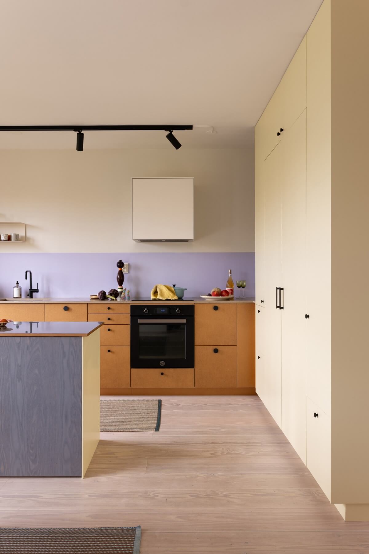 modern kitchen with island and lavender backsplash