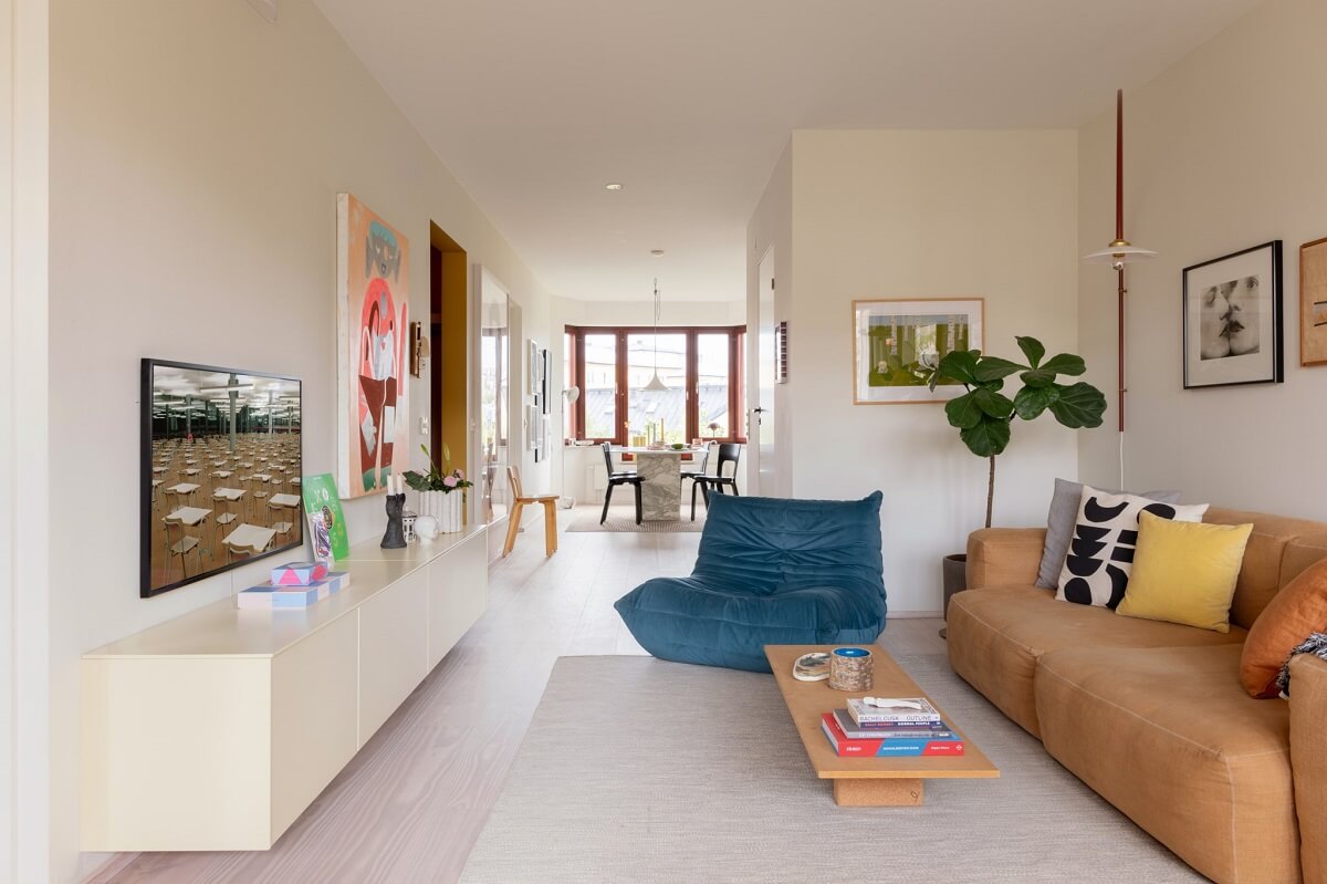 modern open plan living room with blue ligne roset togo chair