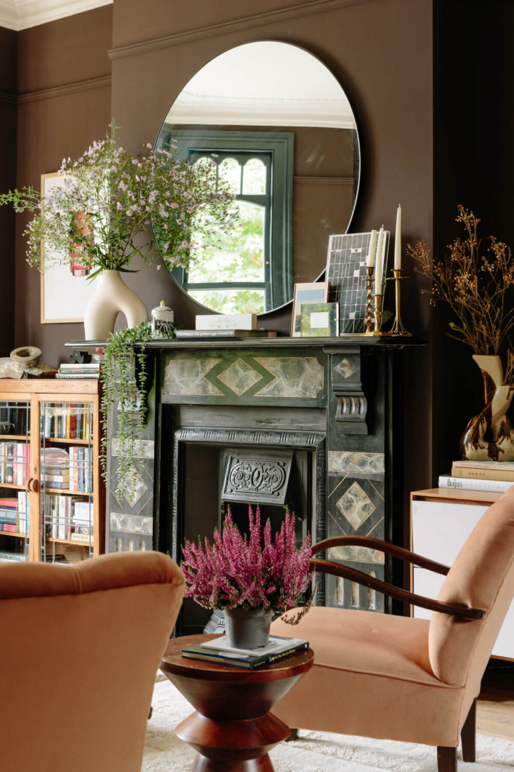 period living room with fireplace round mirror and brow walls color trends 2025 nordroom