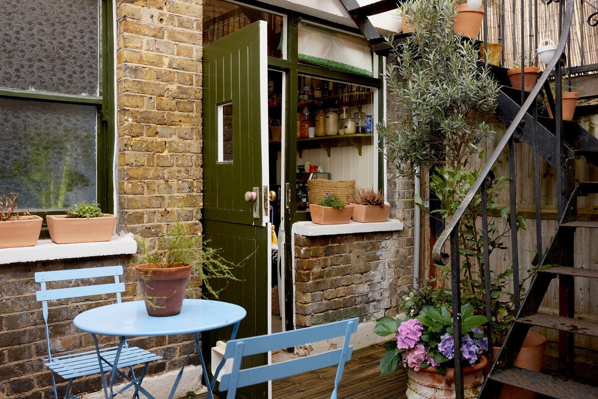 small outdoor space blue bistro seating