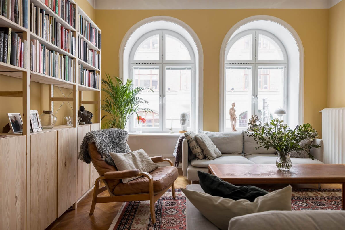 yellow living room with arched windows and ikea ivar bookcases nordroom