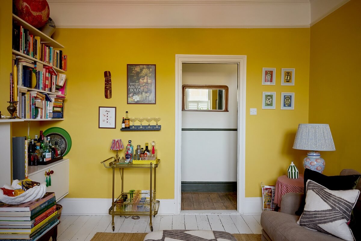 yellow walls living room bookshelves