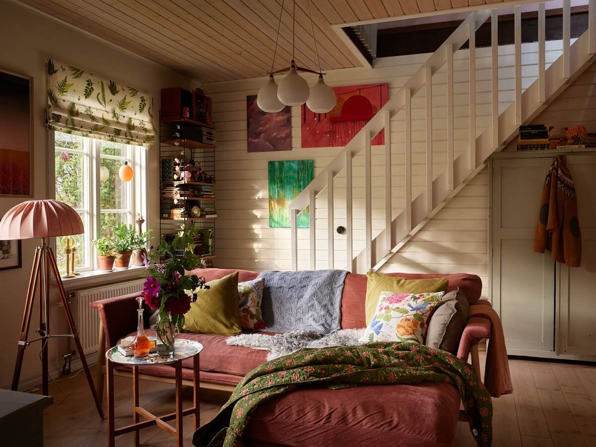 art filled living room pink couch
