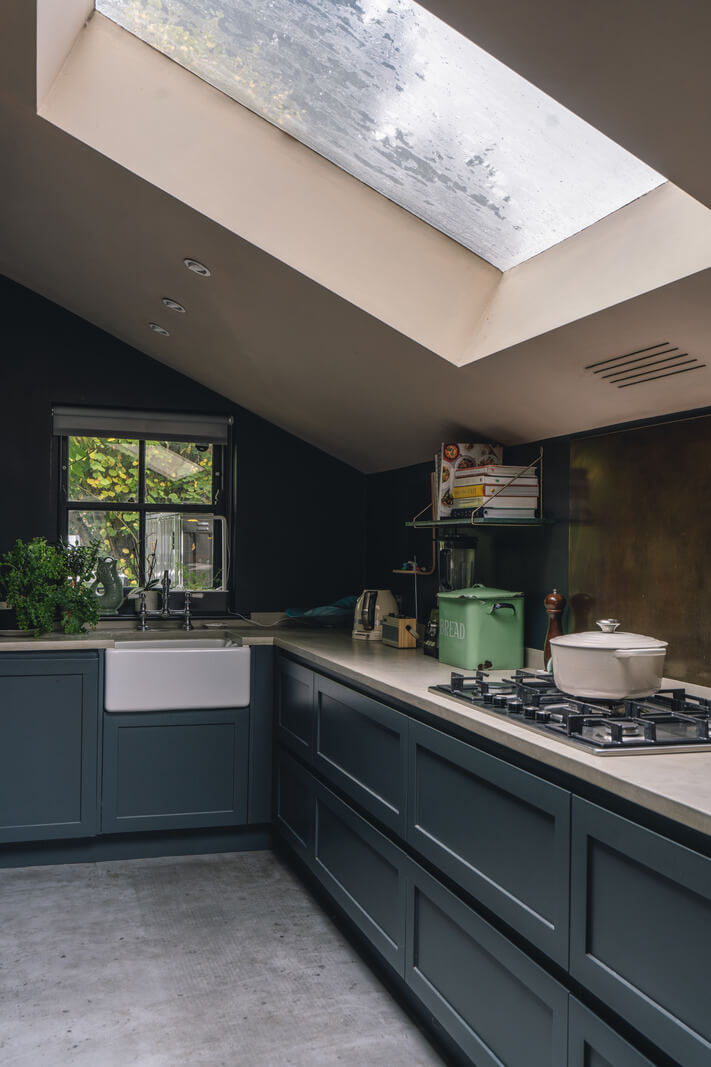 blue kitchen cabinets with slanted ceiling and large skylight nordroom