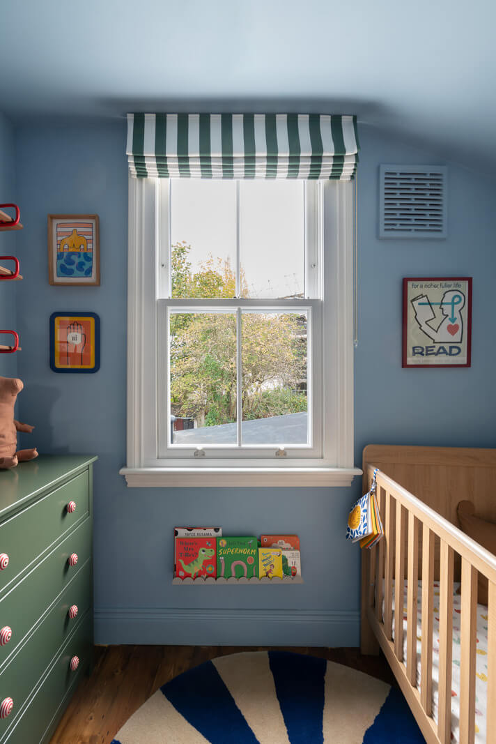 blue nursery with striped curtains