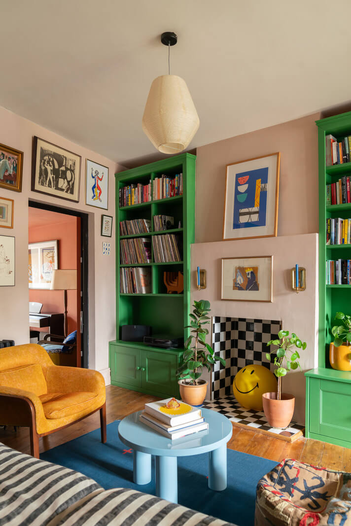 colorful living room striped sofa green built in bookcases