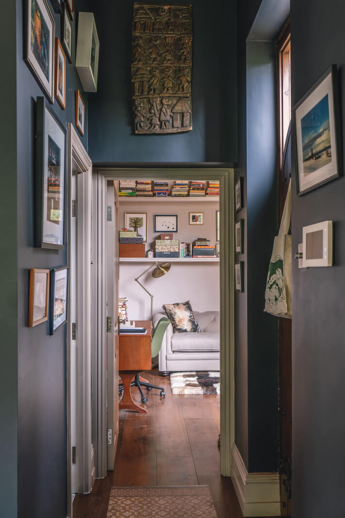 dark blue hallway with art