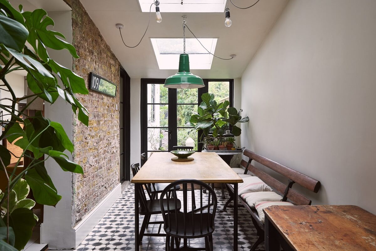 dining room skylights tiled floor brick wall