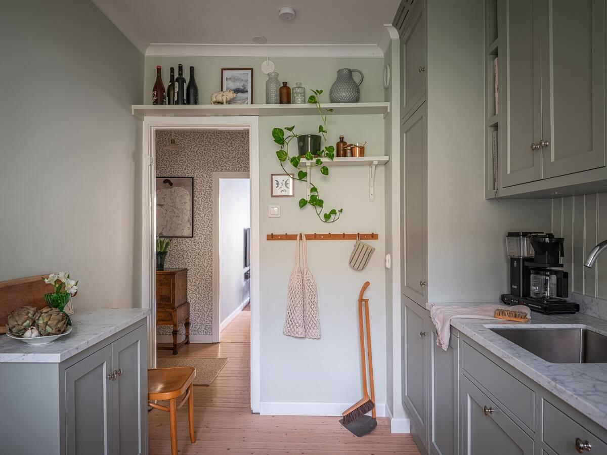 gray kitchen with shelf above door