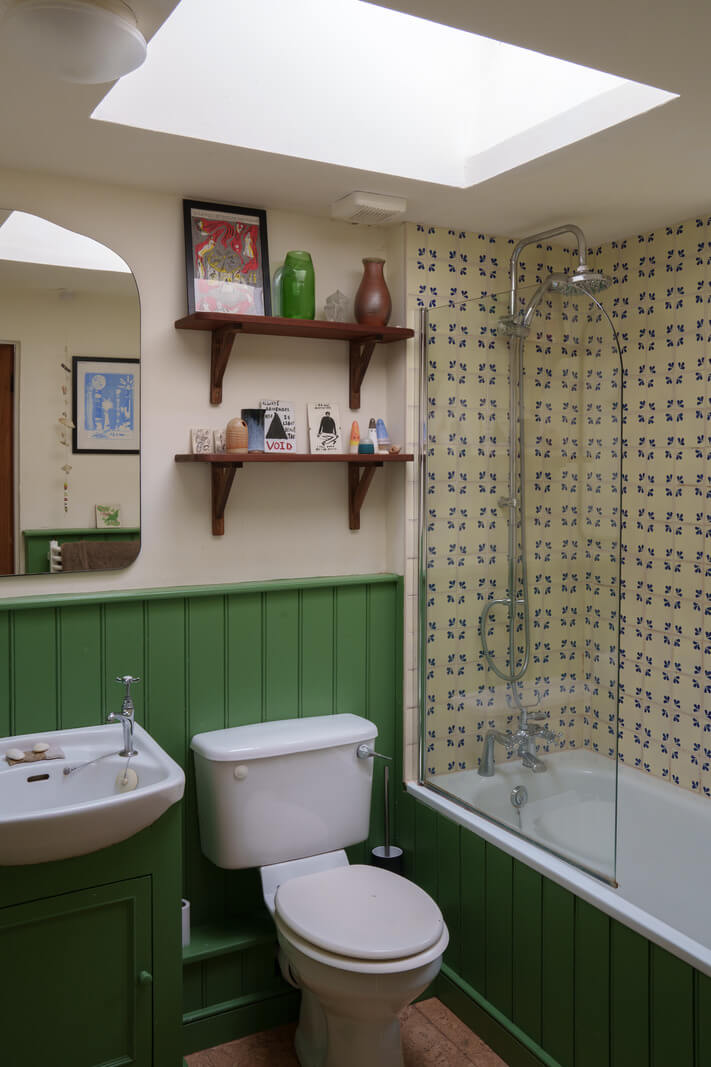 green bathroom with skylight