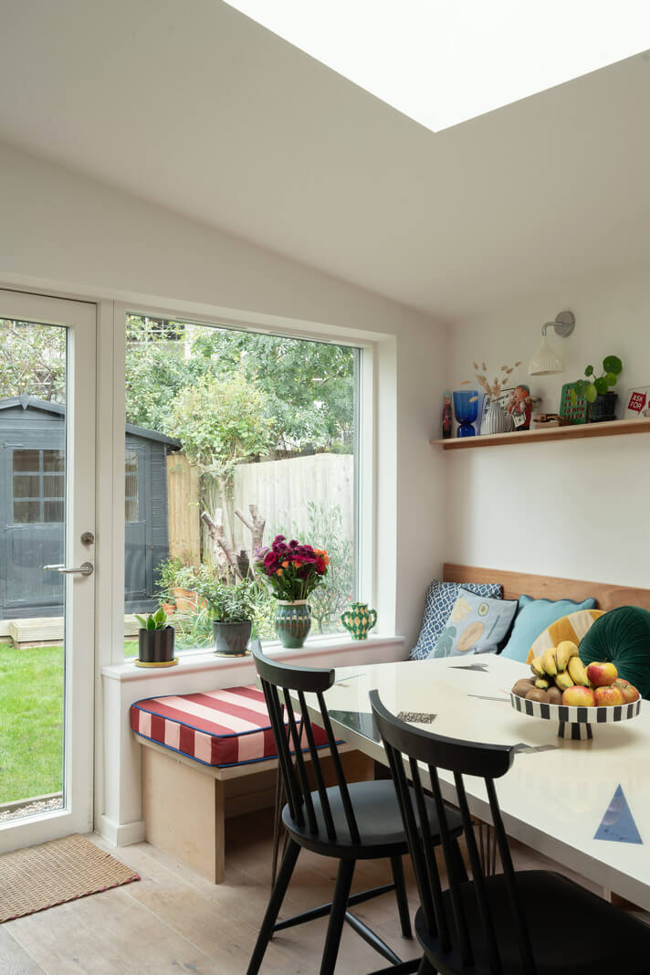 kitchen dining area with built in bench and skylight