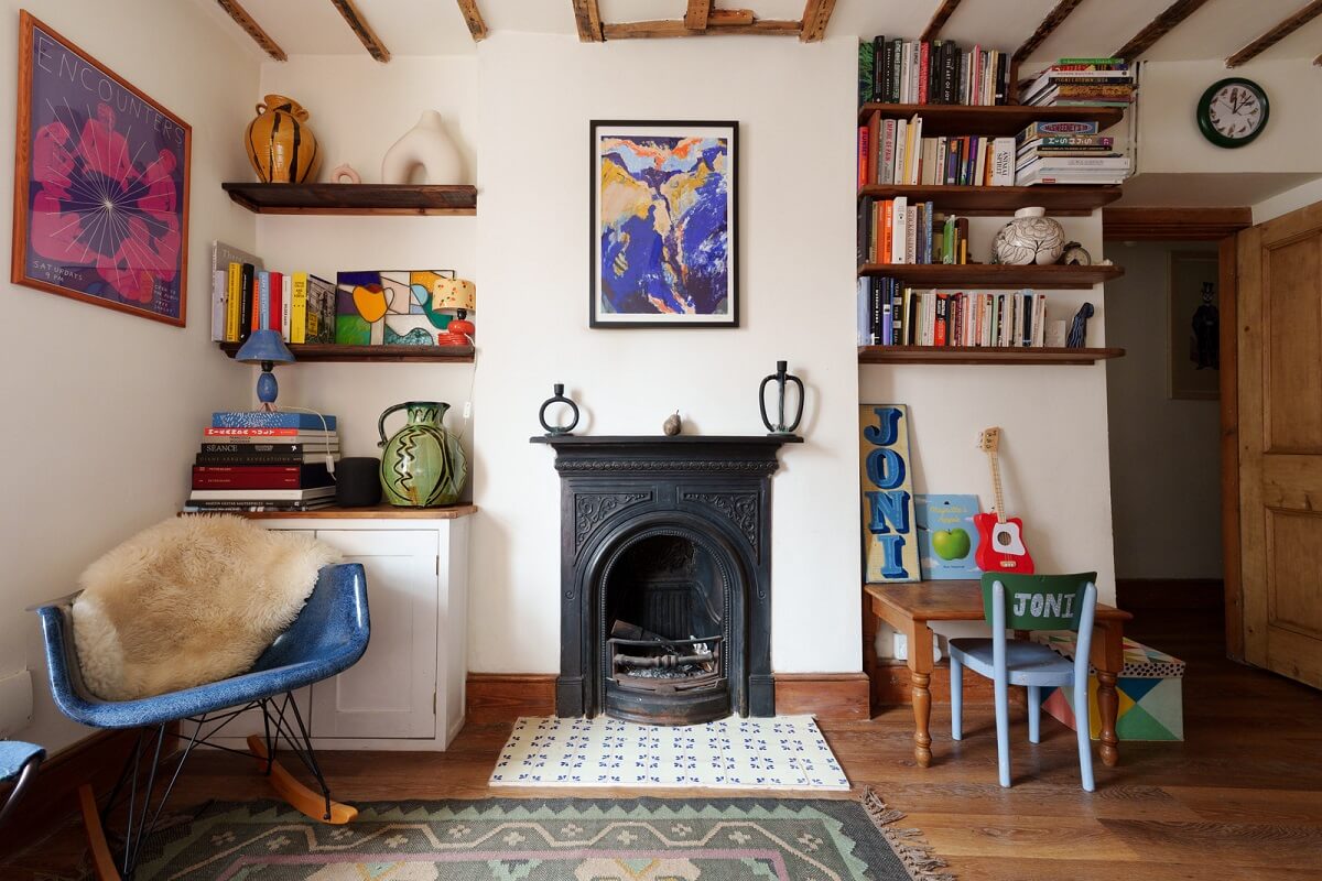 living room black fireplace wooden beams bookshelves