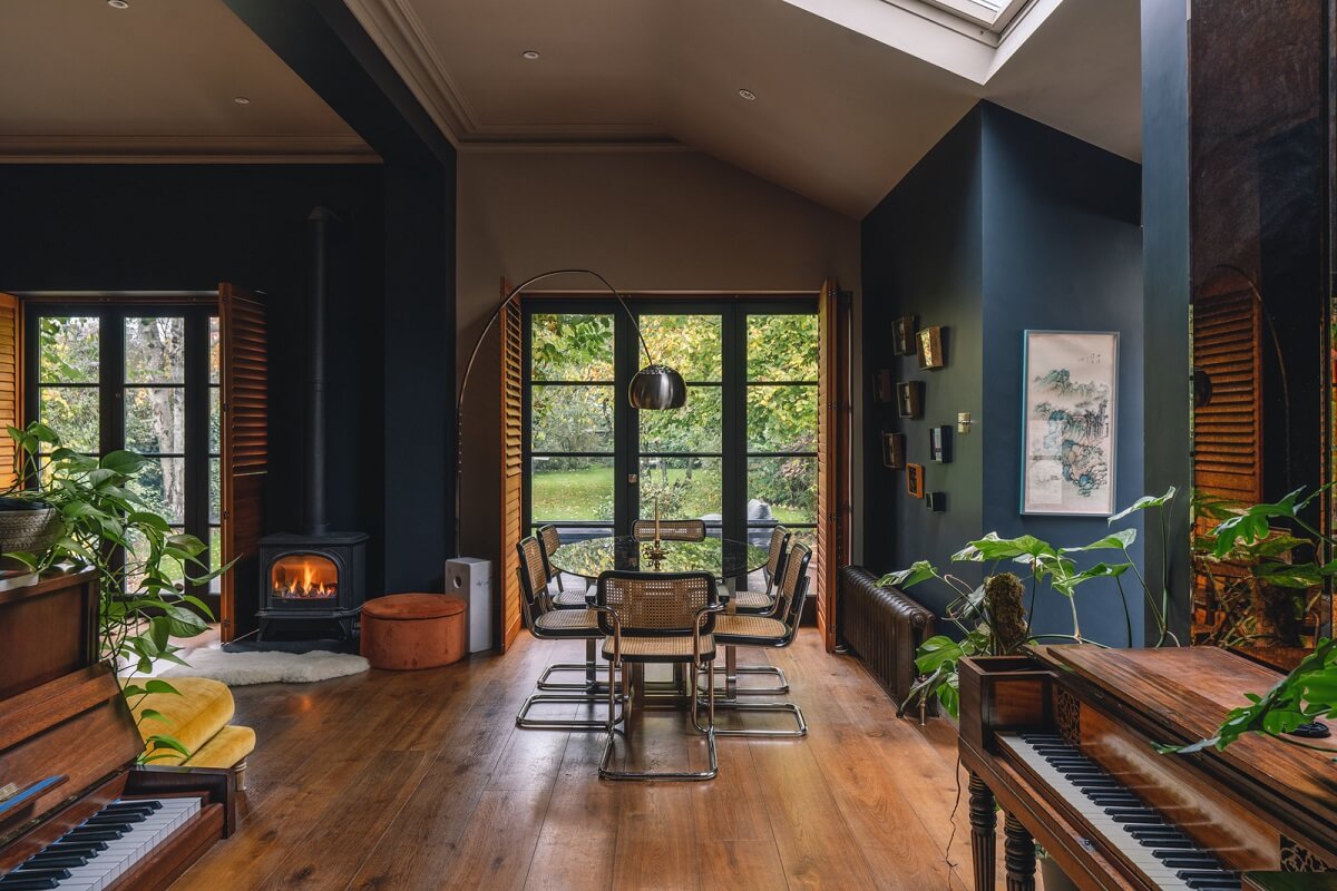 living room dark blue walls high ceiling wooden floor and brown shutters nordroom