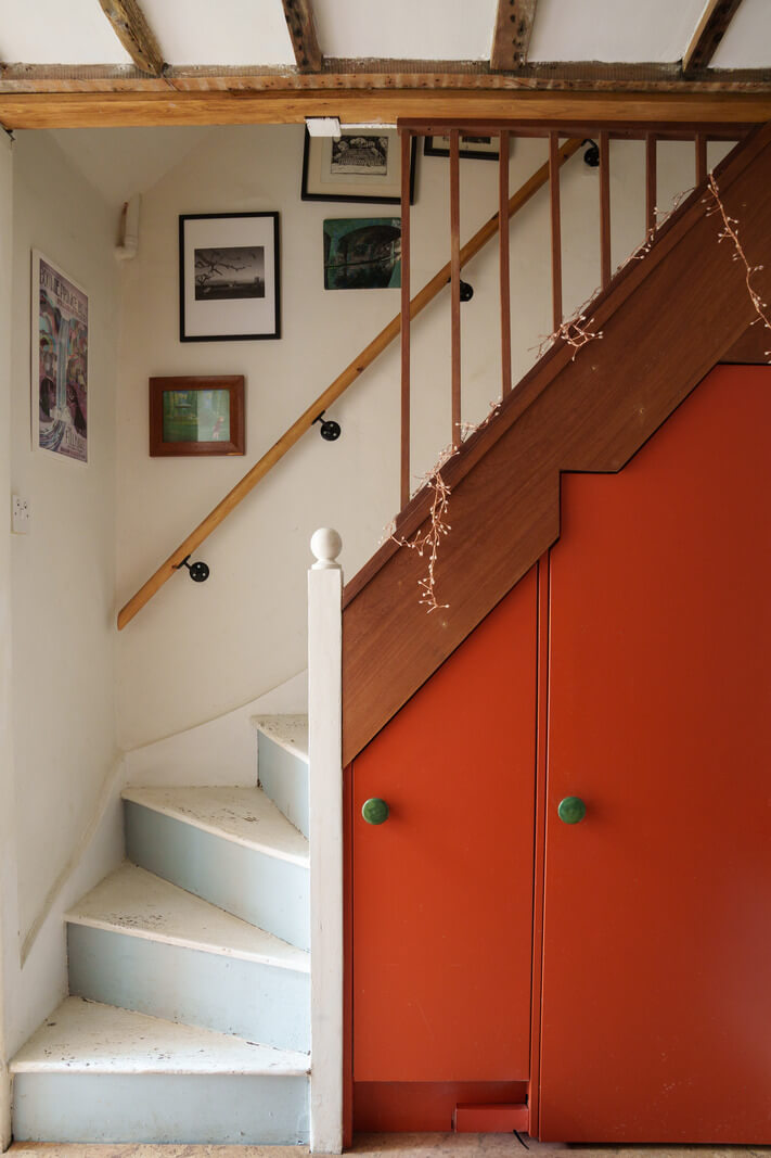 orange cabinets under stairs