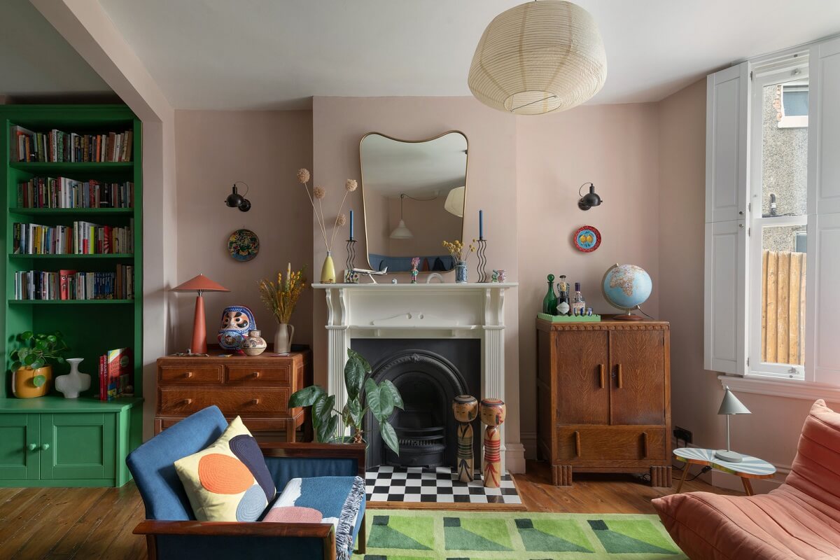 pink living room with firelace and bay window