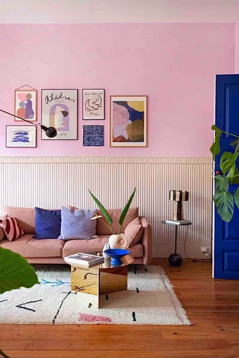 pink living room wooden floor blue door