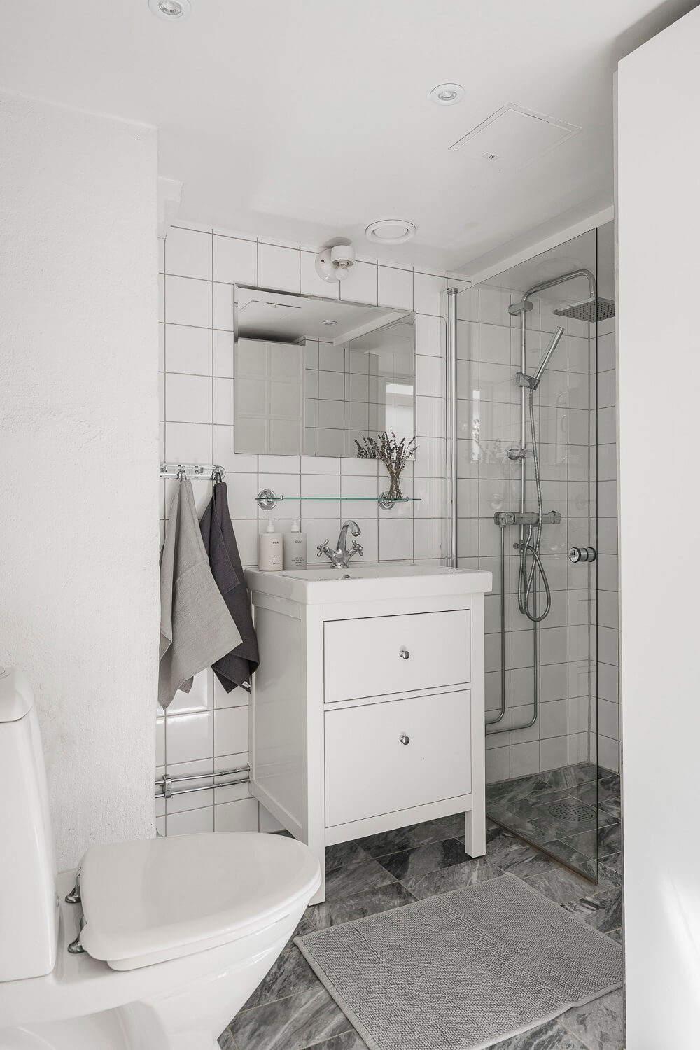 small bathroom with marble tiles A Swedish Attic Apartment with a Lovely Balcony Overlooking the City