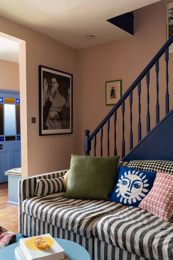 striped couch and blue staircase