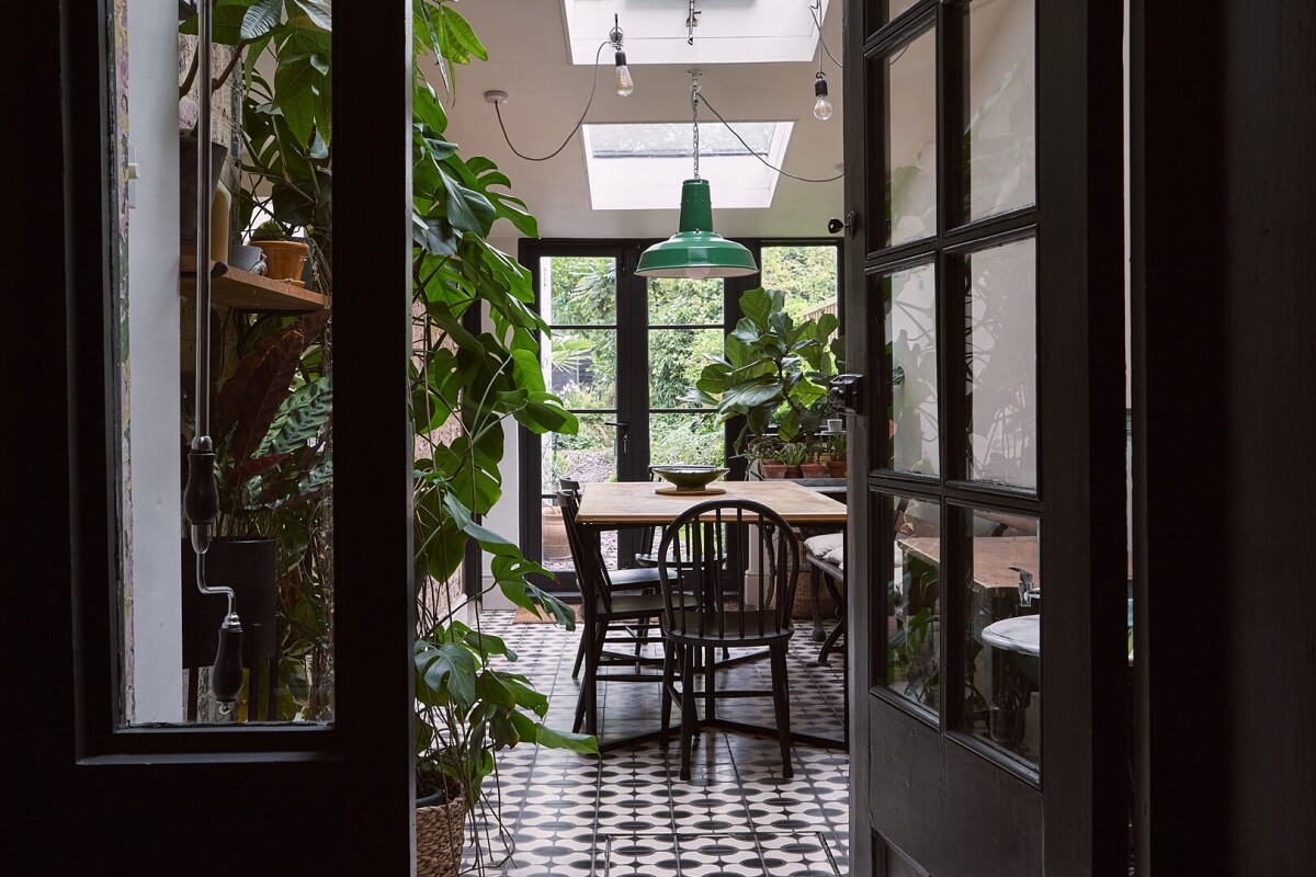 view into plant filled dining room