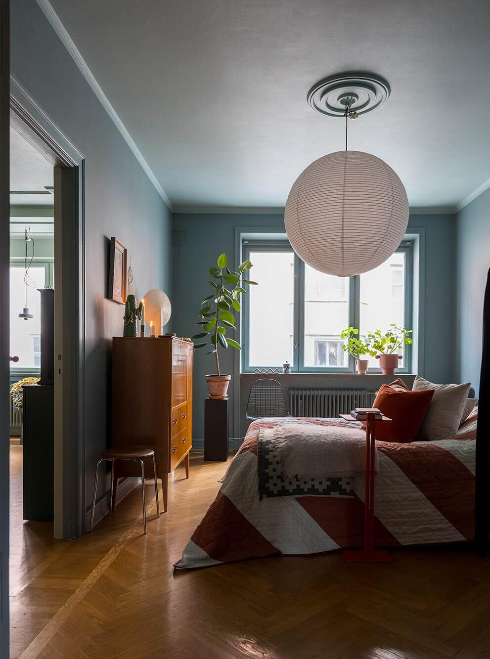moody gray bedroom with colorful textiles
