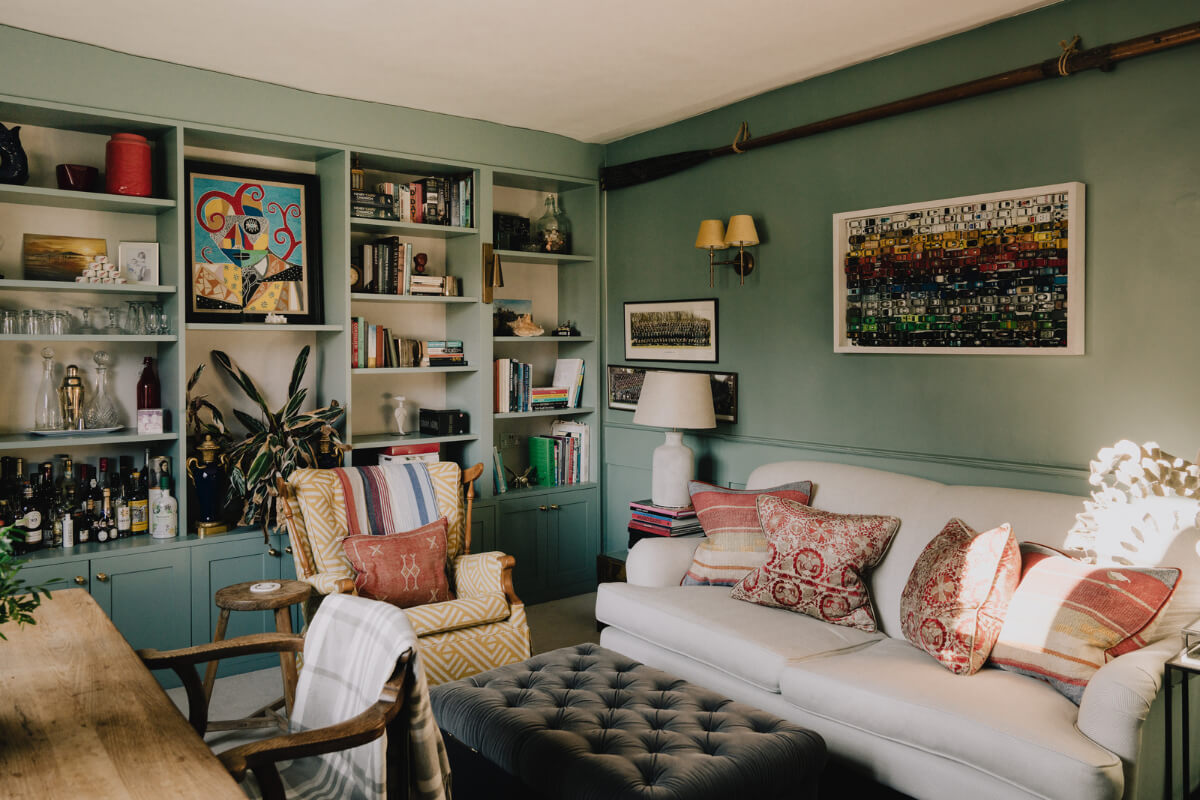 small green living room with bookcases