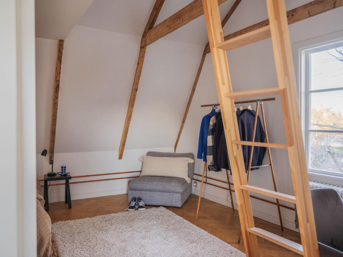 attic bedroom with clothing rack